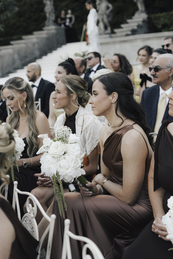 Guests seated beside the lake for the wedding ceremony at Villa Pizzo.