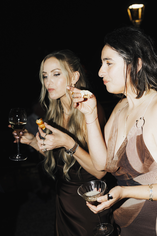 Two friends enjoy late-night food together at Villa Pizzo.