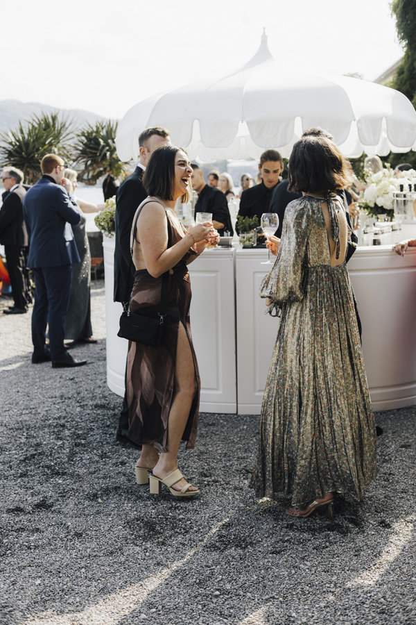 Guests talk beside an outdoor bar during the Villa Pizzo aperitivo.