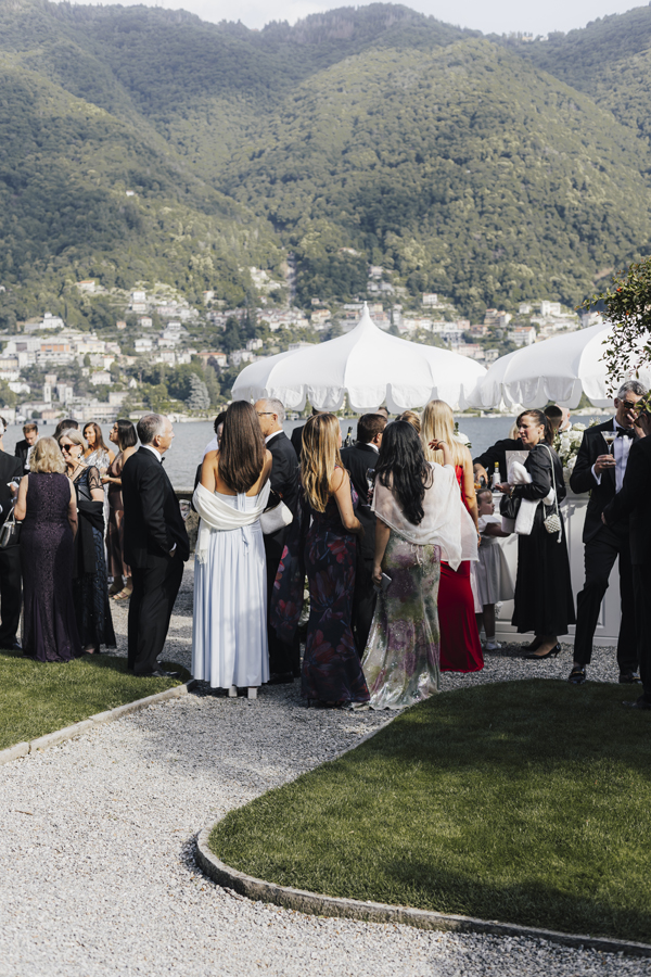 Guests gather outdoors for aperitivo after the Villa Pizzo wedding ceremony.