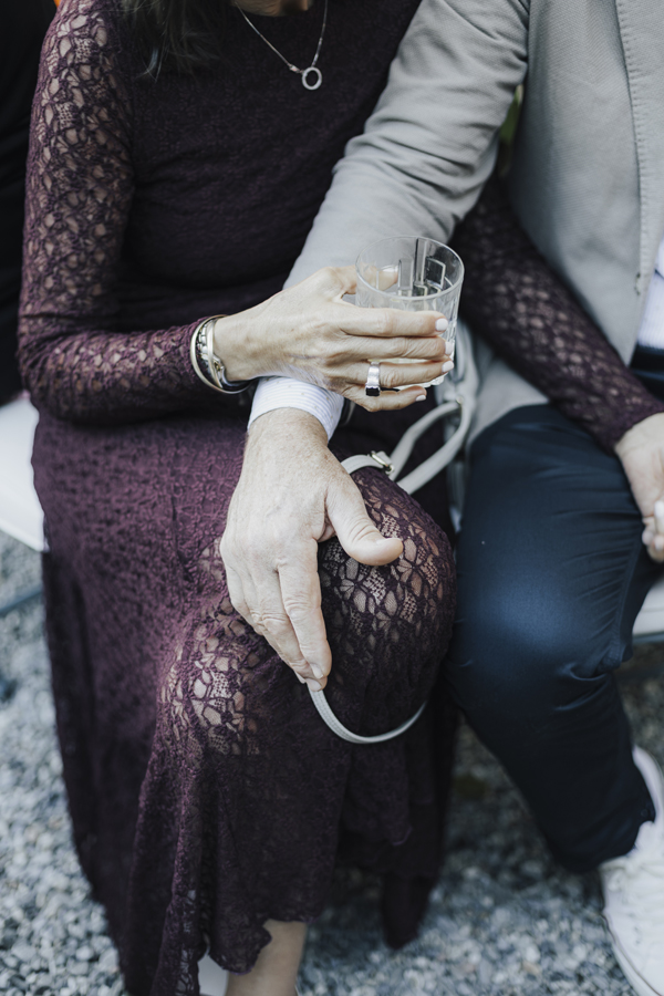 Close-up of guests seated together with a drink and handbag at Villa Regina Teodolinda.