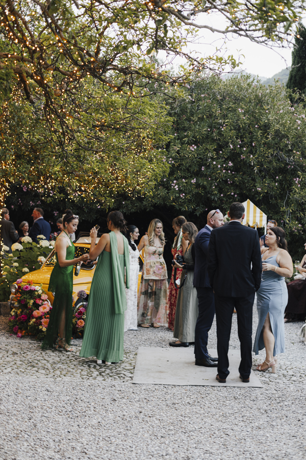Guests gather beneath the trees in the garden at Villa Regina Teodolinda.