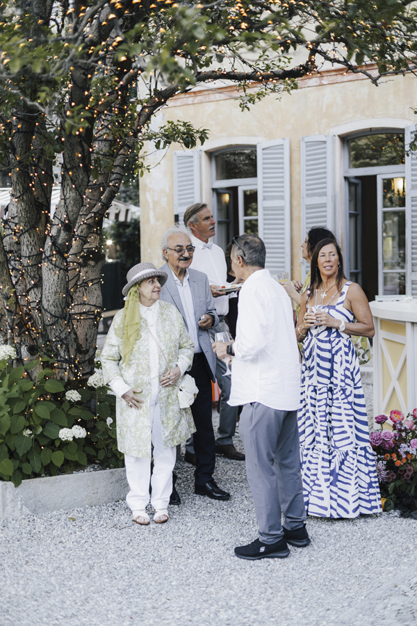 Guests talk outside the villa during the gathering at Villa Regina Teodolinda.
