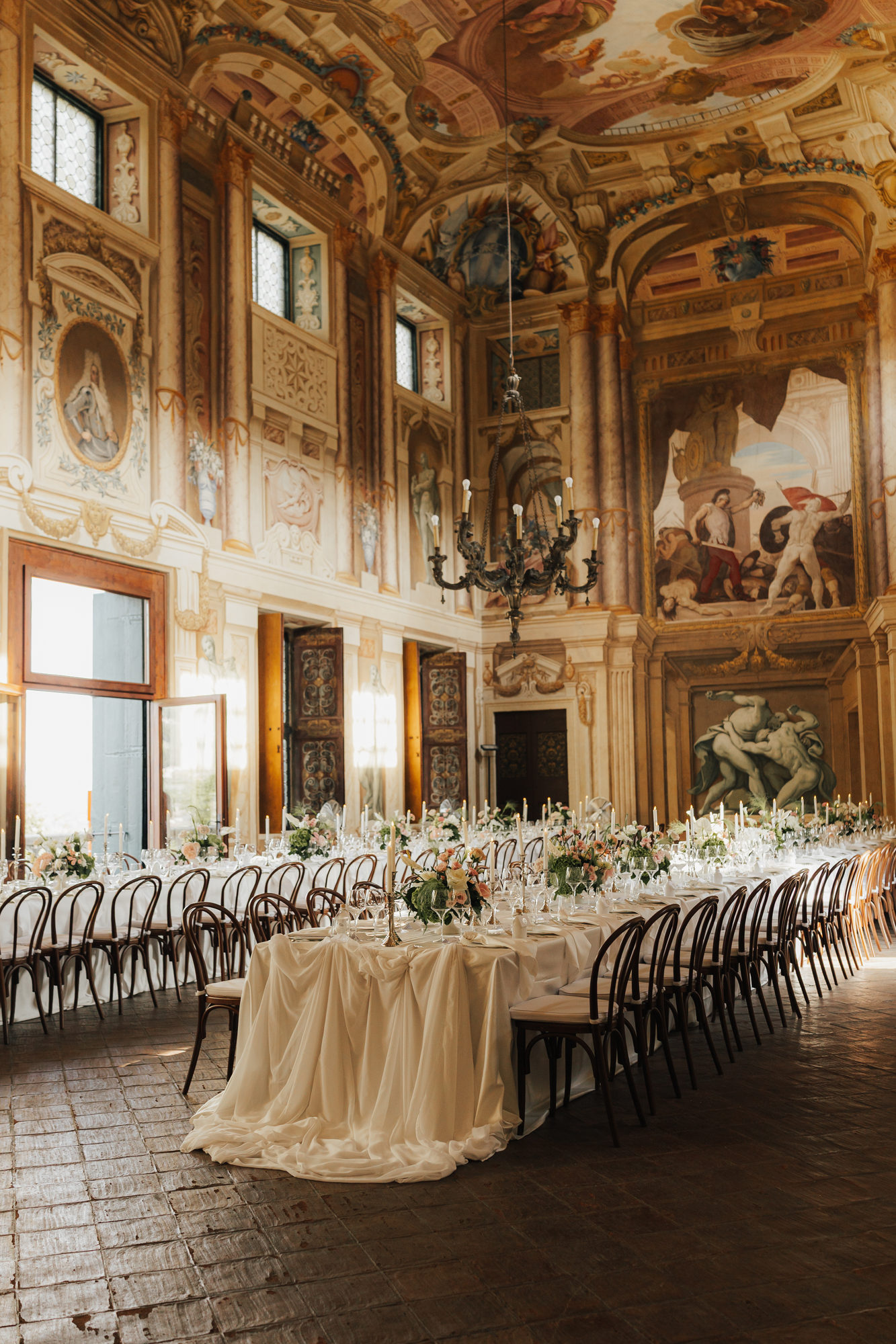 Grand frescoed reception hall at Villa Arvedi set for dinner