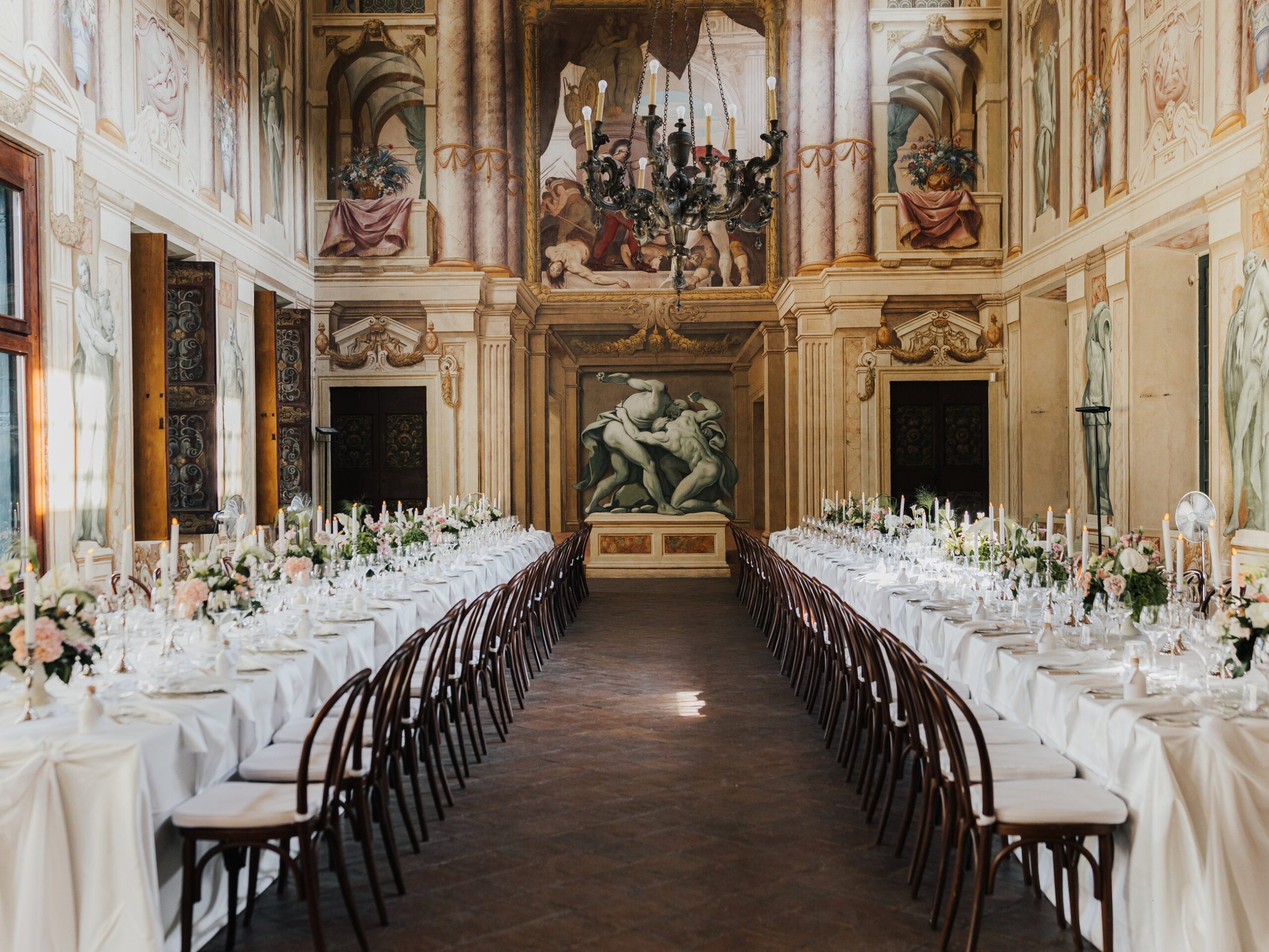 The frescoed reception hall of Villa Arvedi prepared for dinner