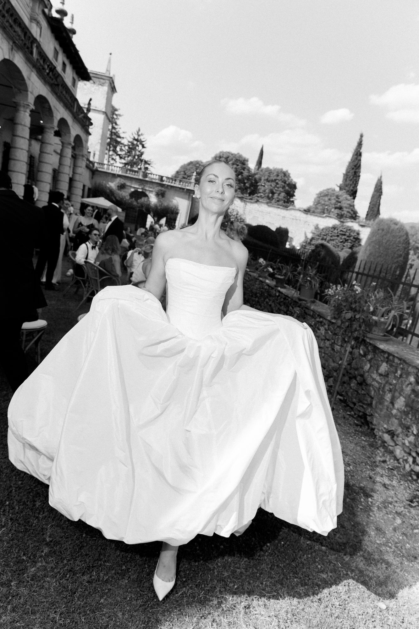 Bride moving through Villa Arvedi in a sculptural white gown