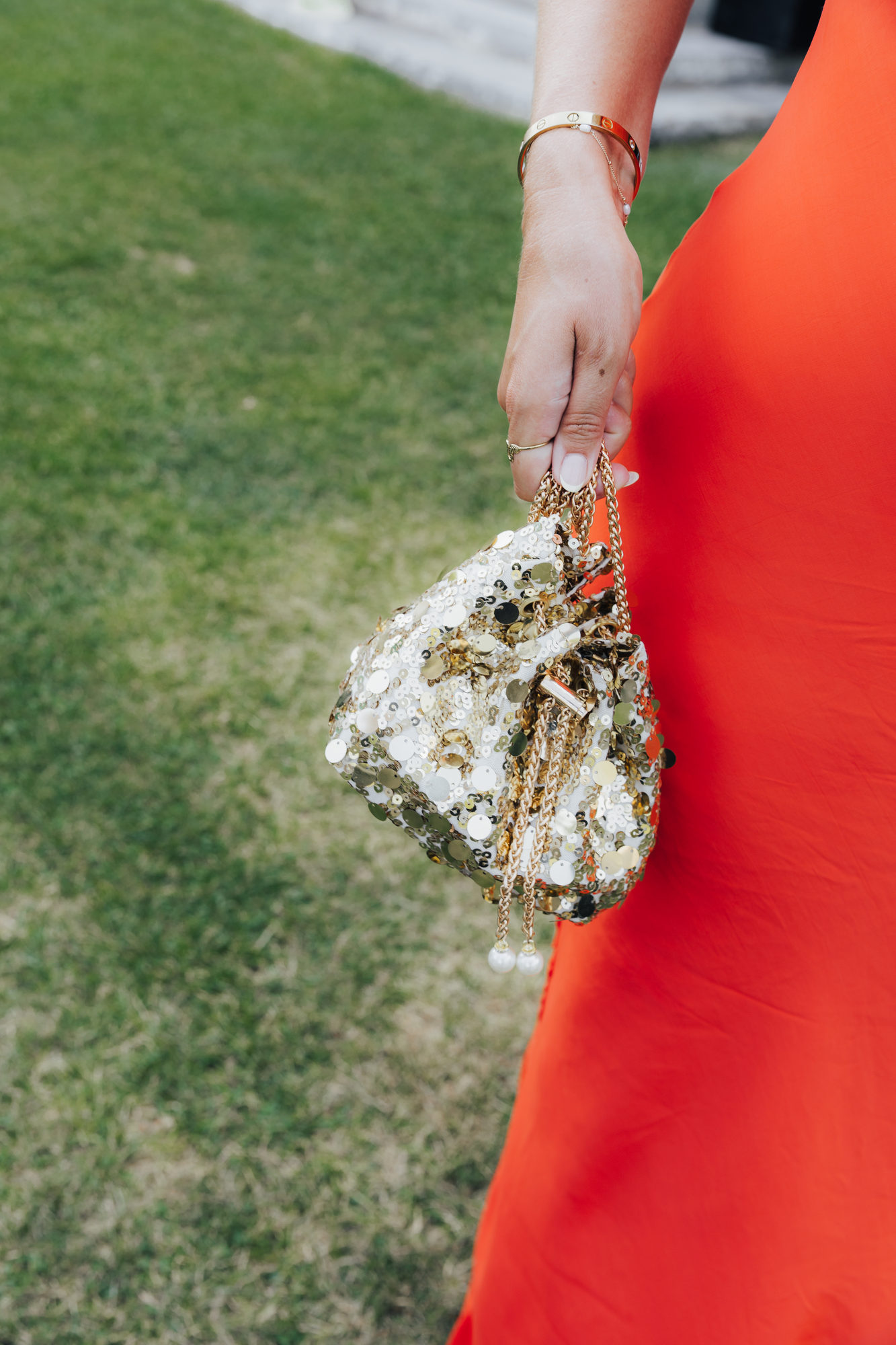 A jeweled evening bag against a vivid red dress at Villa Arvedi