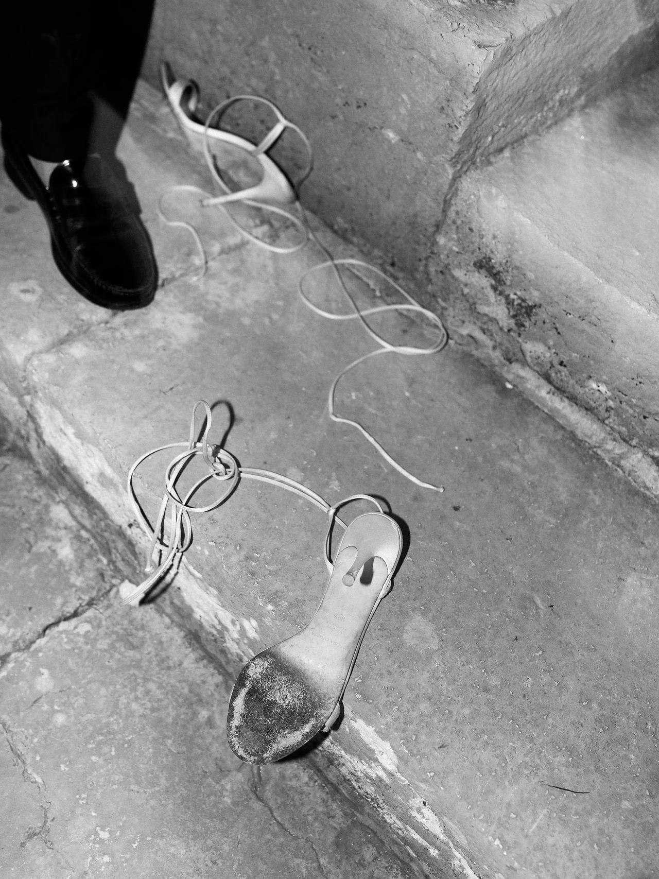 Evening shoes abandoned on the stone steps