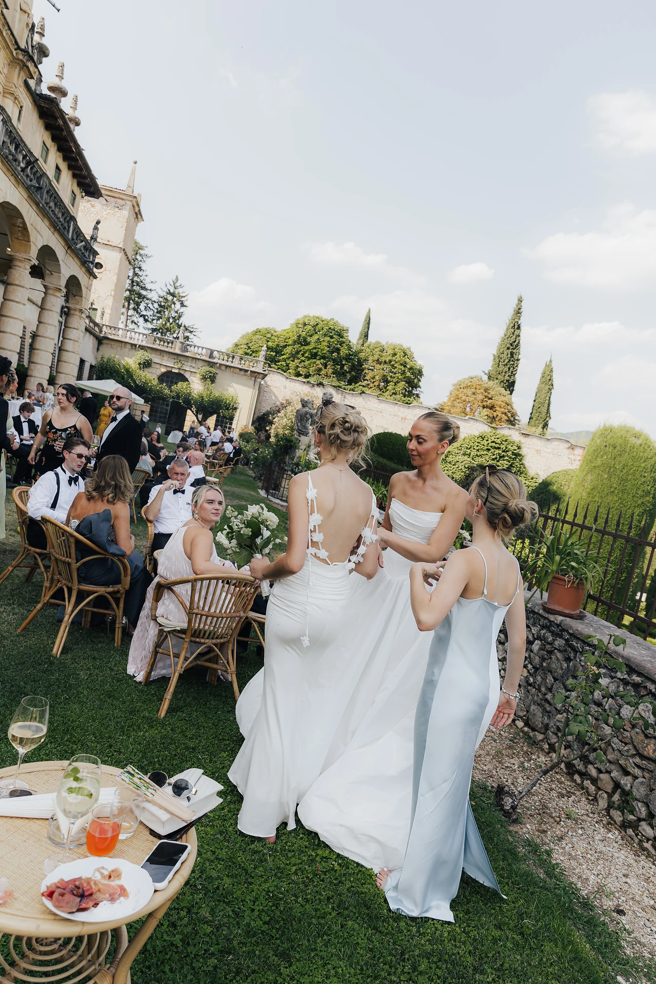 The bride moving through the garden among her guests