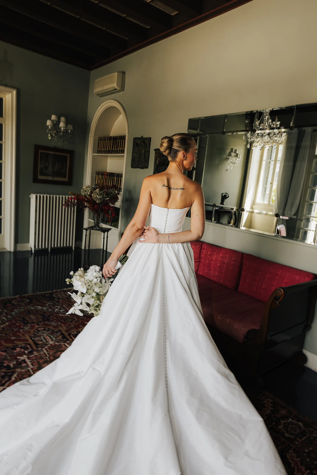 The bride seeing the finished look in the mirror