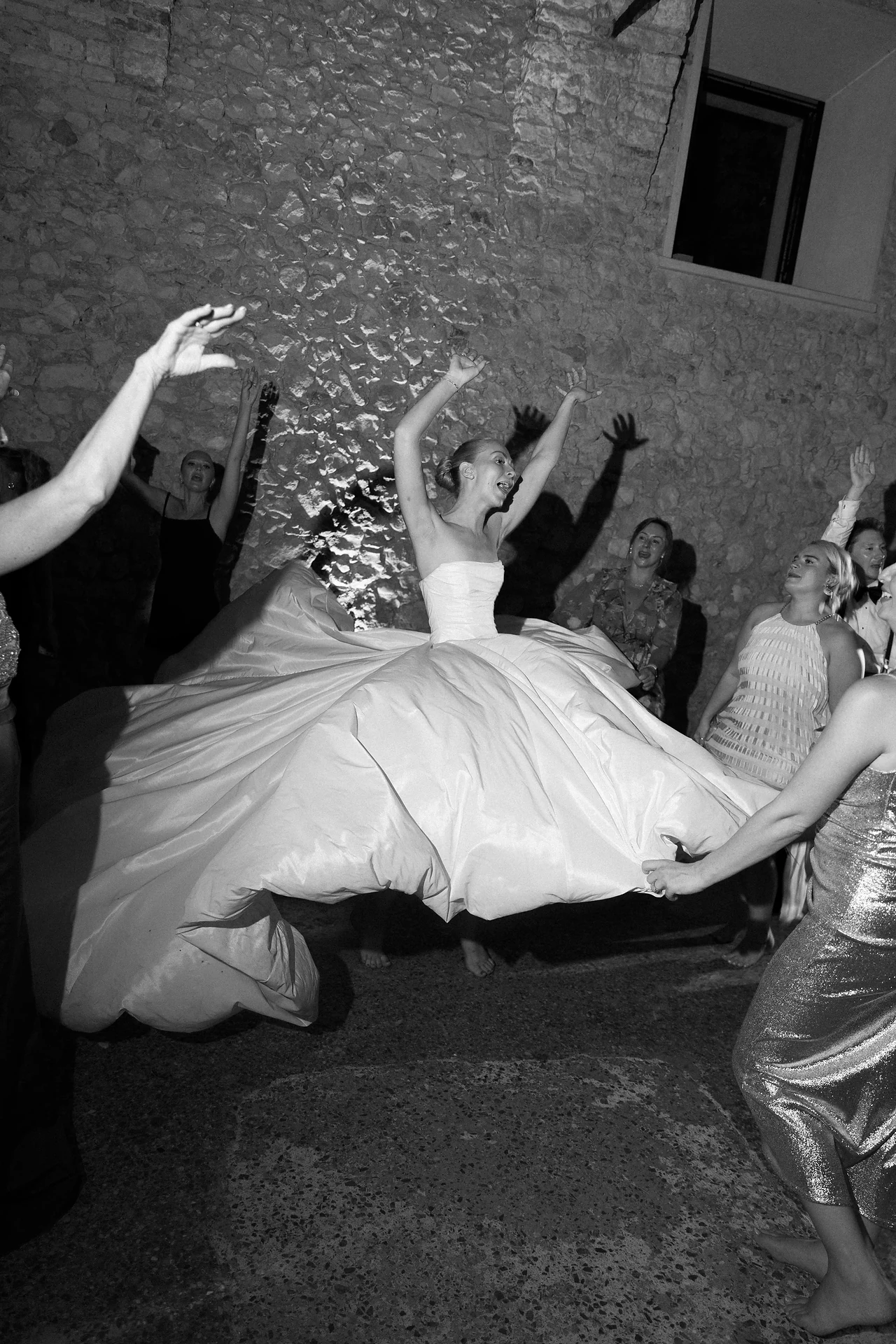 Bride lifted above the dance floor in black and white
