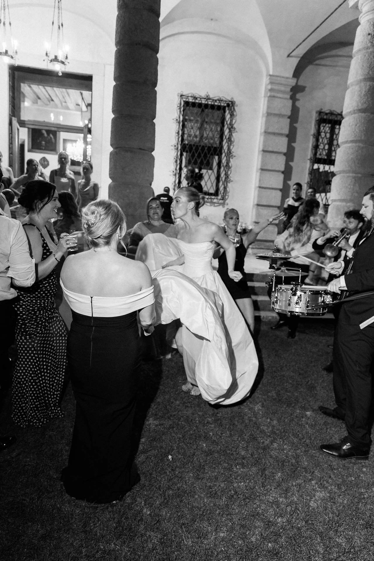 The bride moving through the party in black and white
