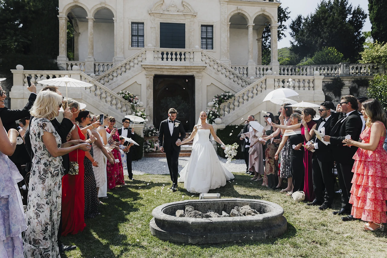 The newlyweds leaving the ceremony between their guests