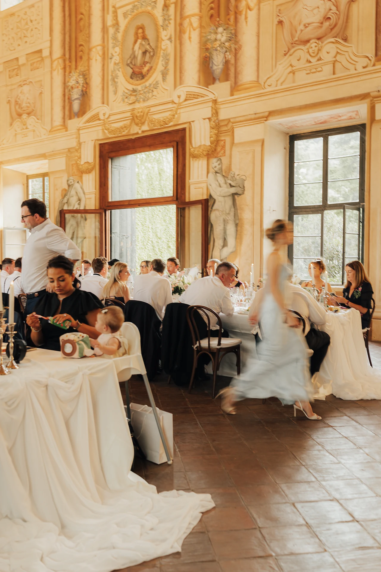 The bride bringing movement into the frescoed hall