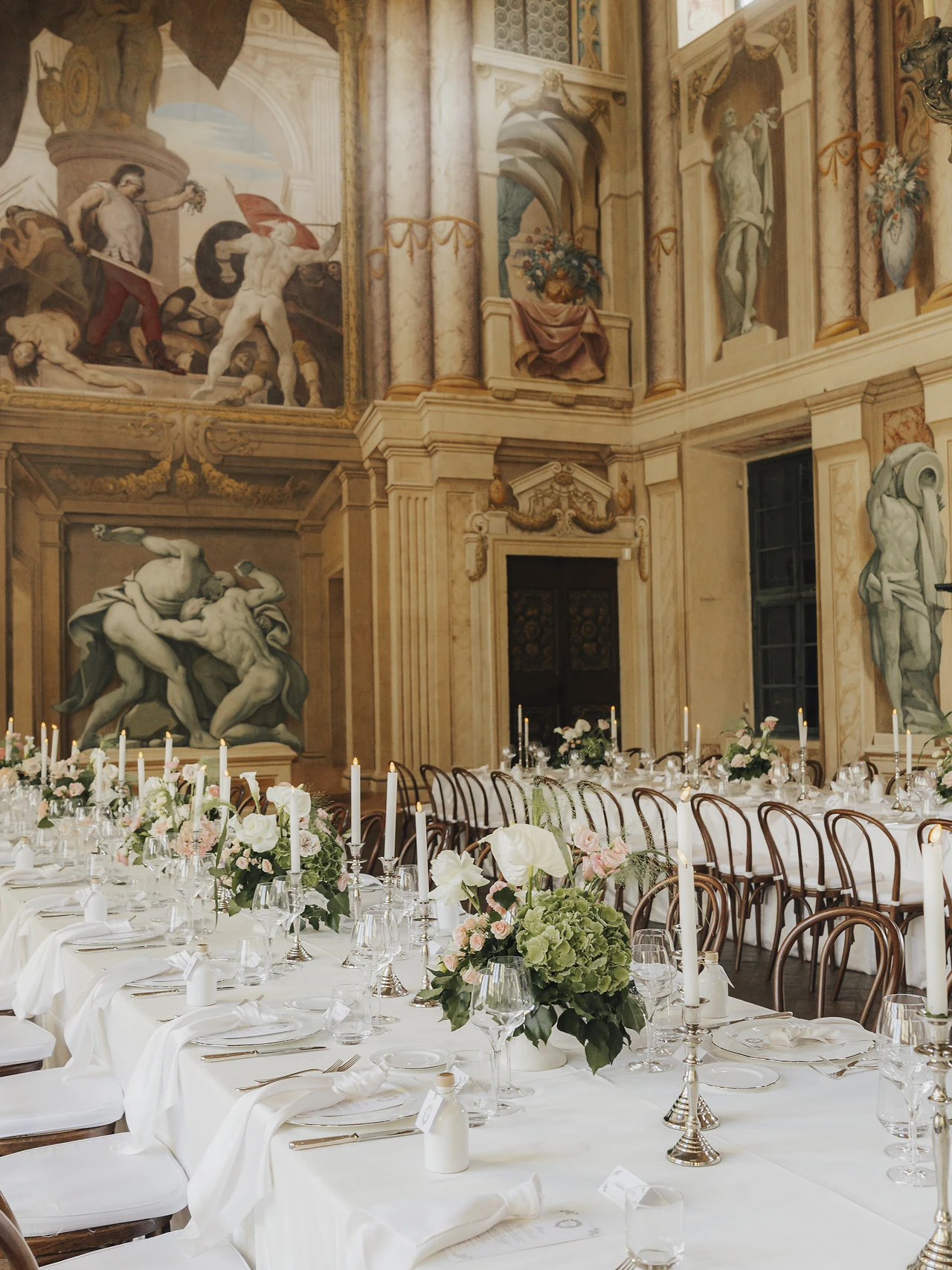 Flowers, candlelight and place settings beneath the frescoes