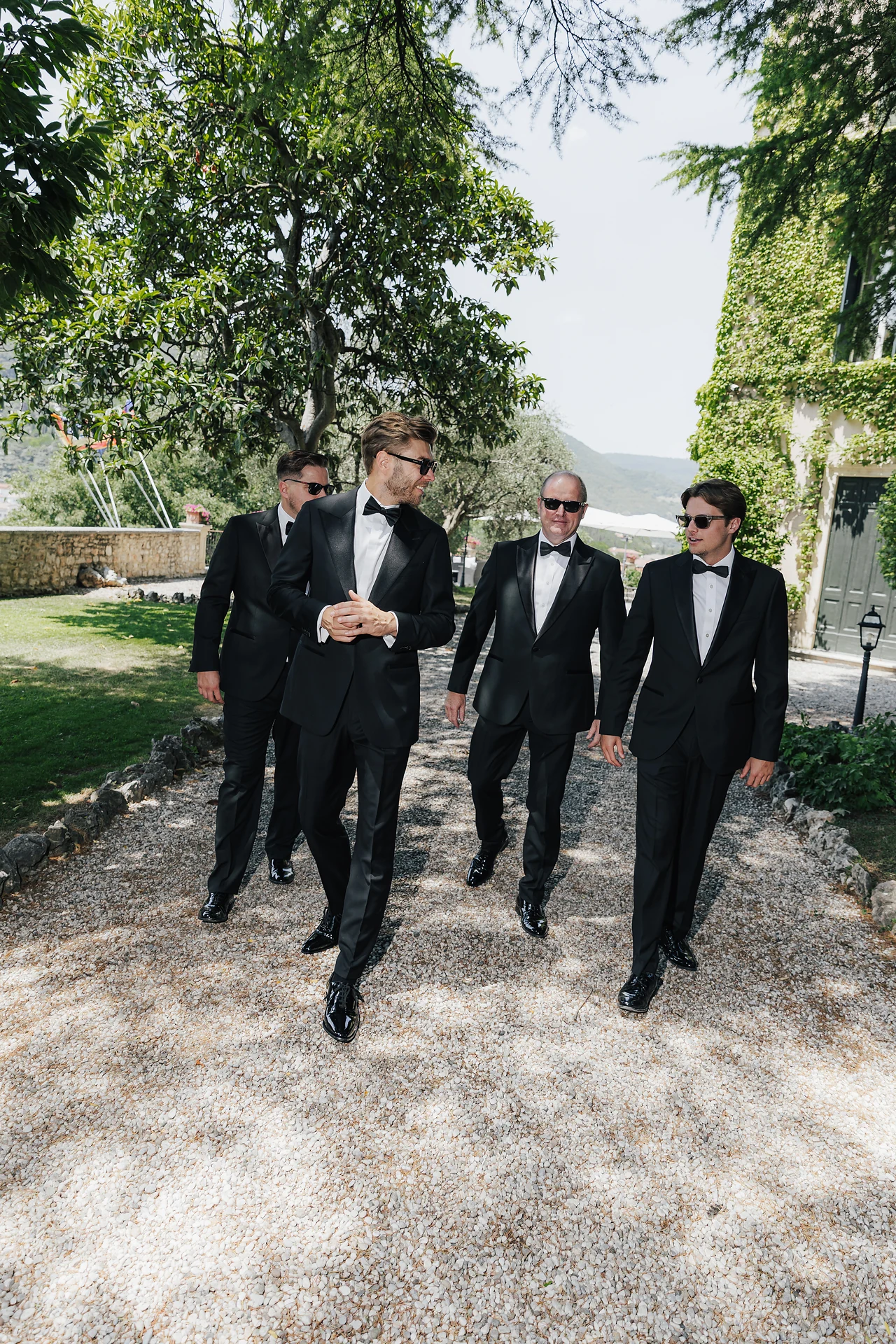 The groom and his friends walking through the villa grounds