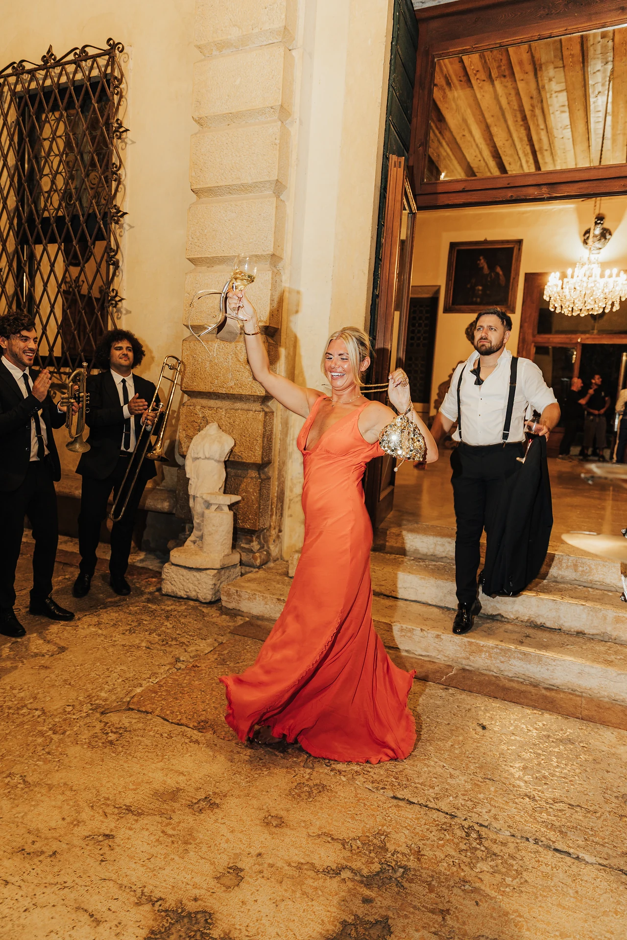 A guest in red crossing the courtyard after dinner