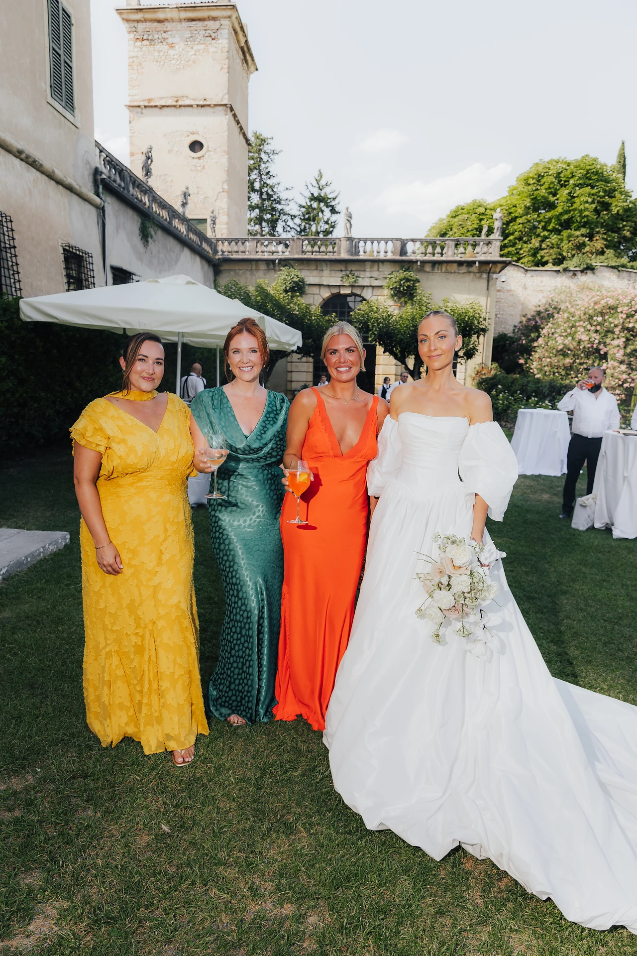 The bride with guests in vivid evening colour
