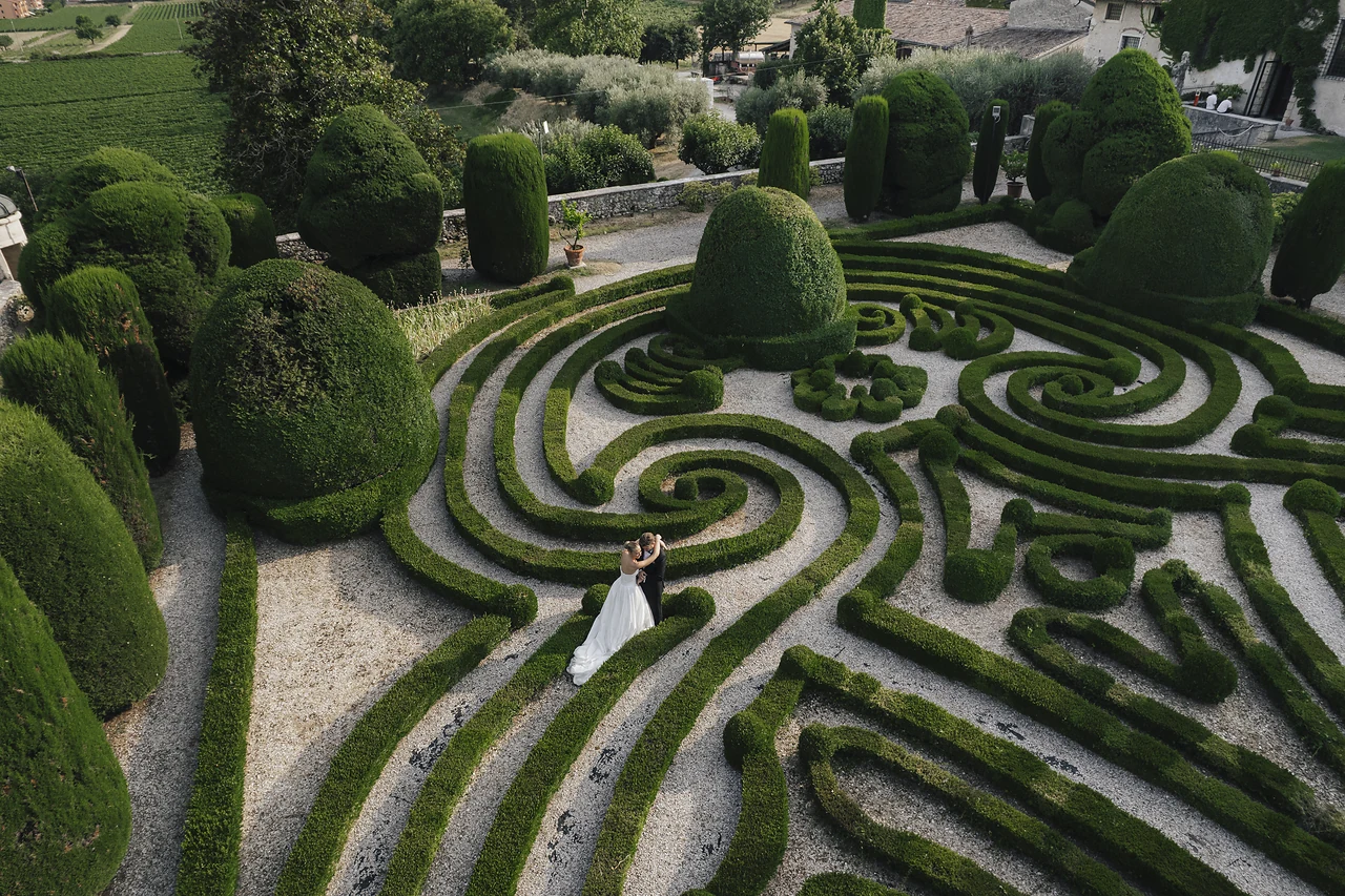 Newlyweds in the labyrinth garden at Villa Arvedi near Verona, photographed from above.
