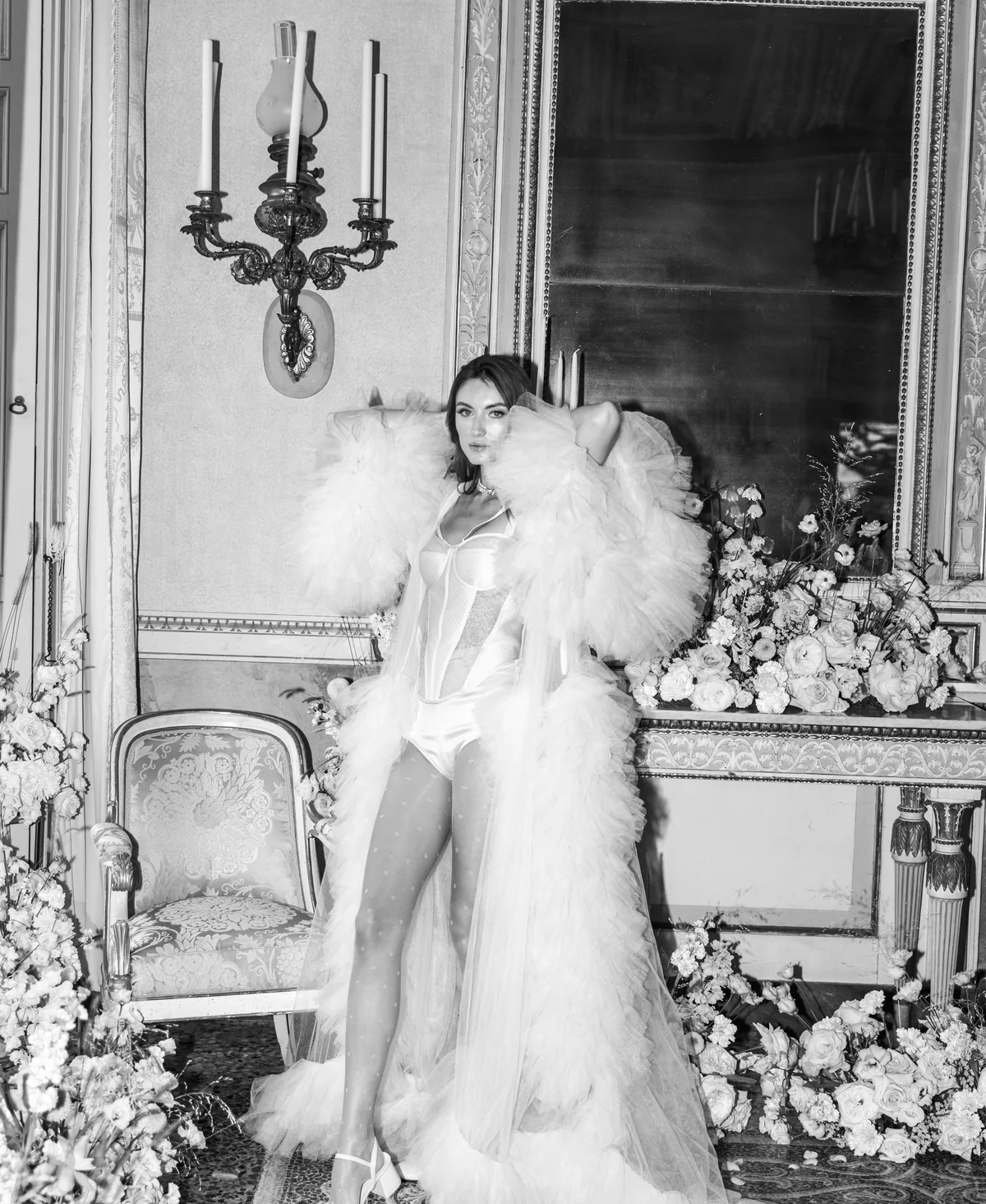 Bride in a feathered couture look inside an ornate Italian villa
