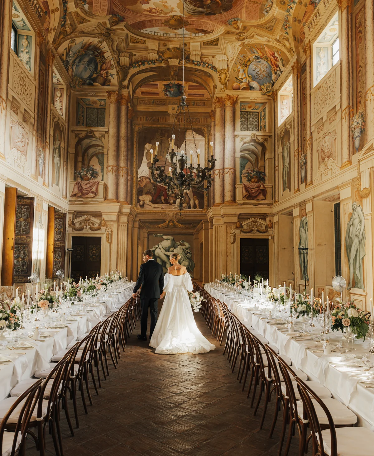 A couple in the frescoed reception hall at Villa Arvedi