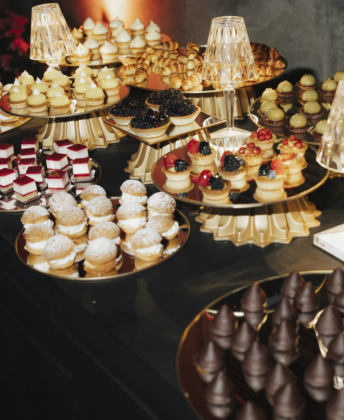 An abundant dessert display on gold trays at Villa Pizzo