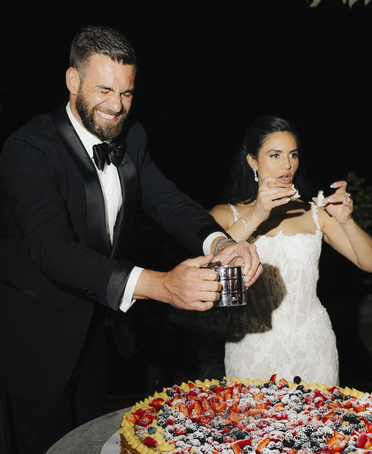 The couple enjoying a berry-covered wedding dessert at Villa Pizzo