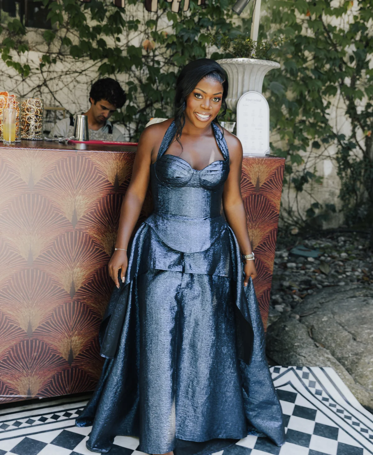 Wedding guest in a sculptural blue evening gown