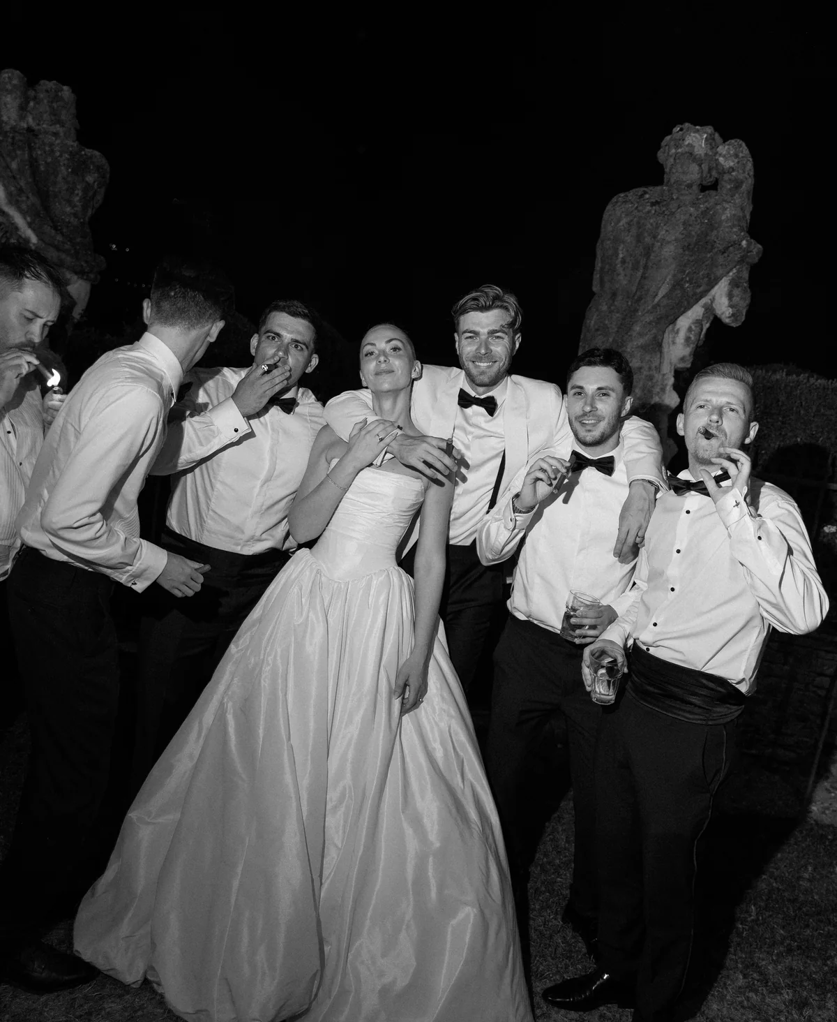 Bride surrounded by friends on the dance floor after dark