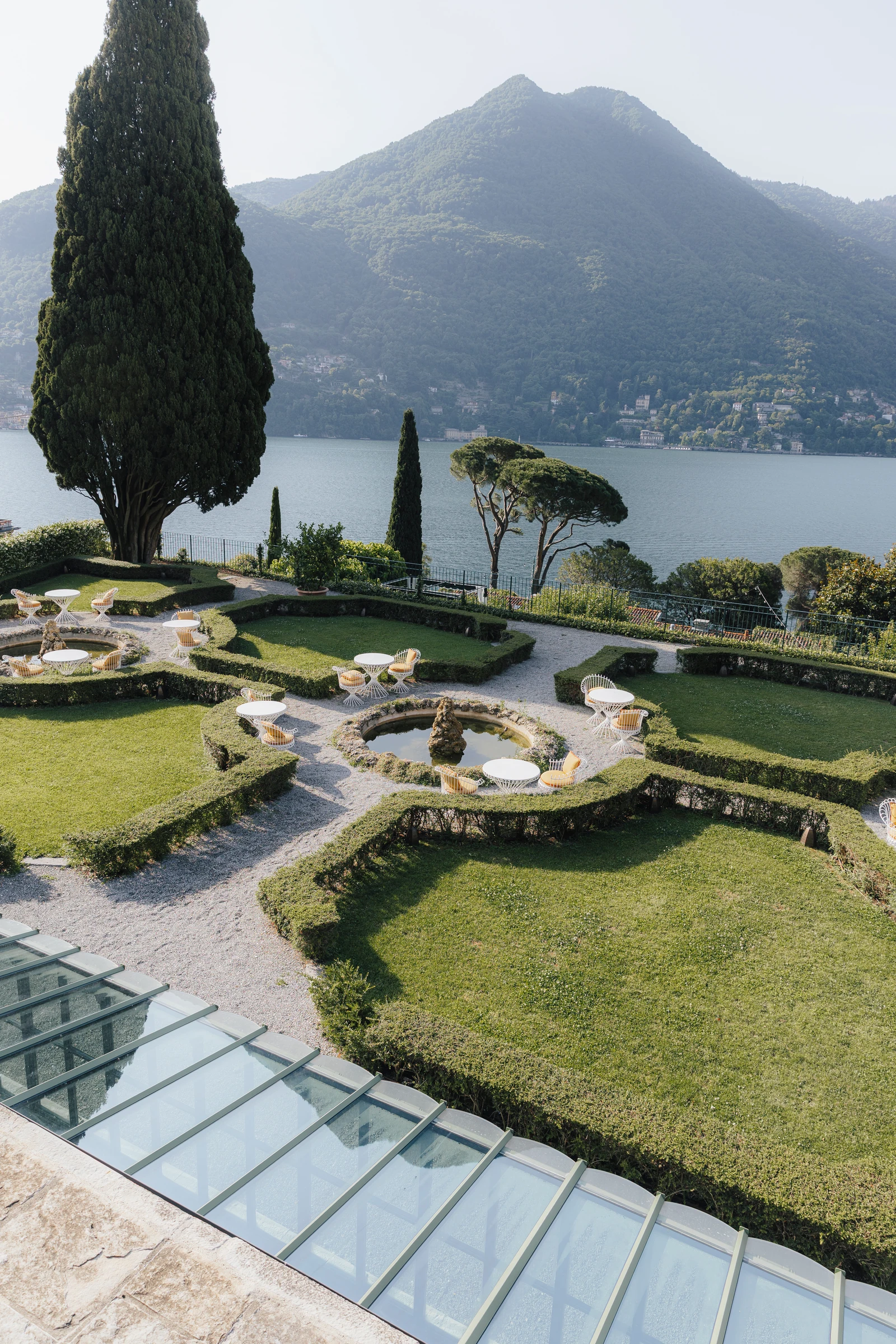 Formal gardens, cypress trees and Lake Como seen from Passalacqua.