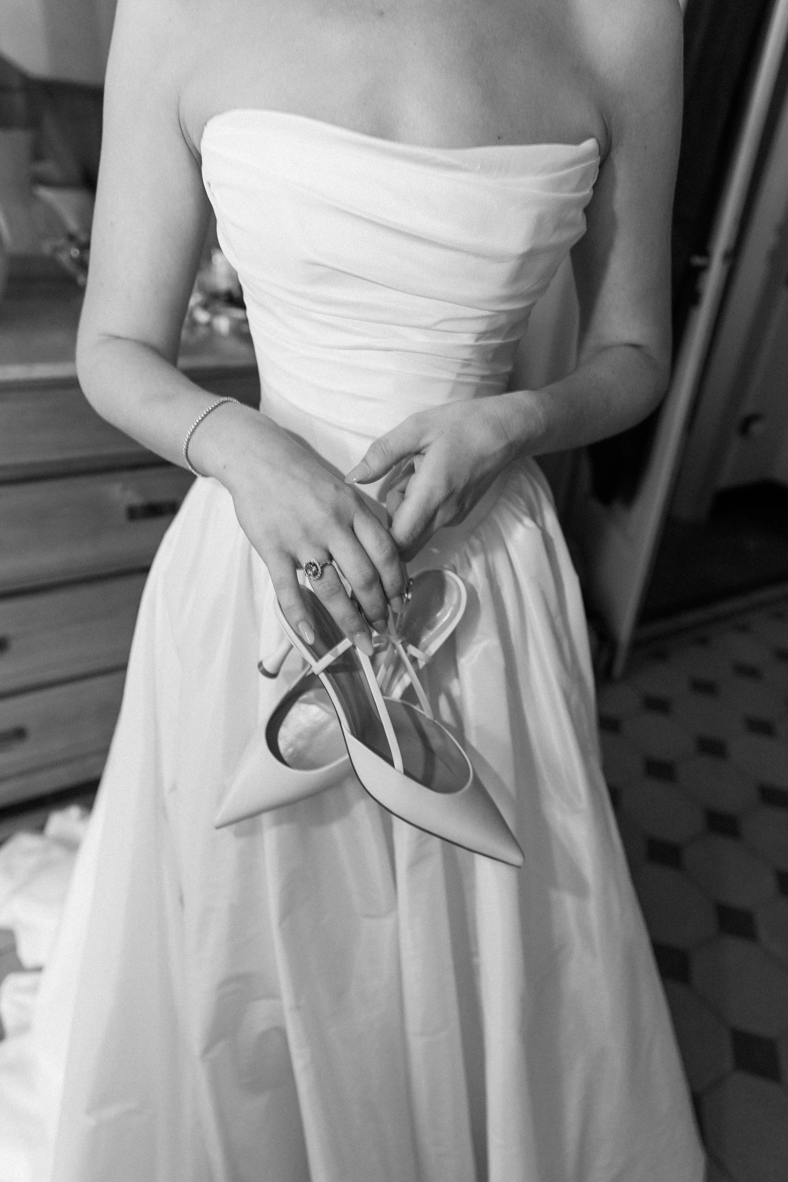 Bride holding her shoes during preparations at Villa Arvedi near Verona.