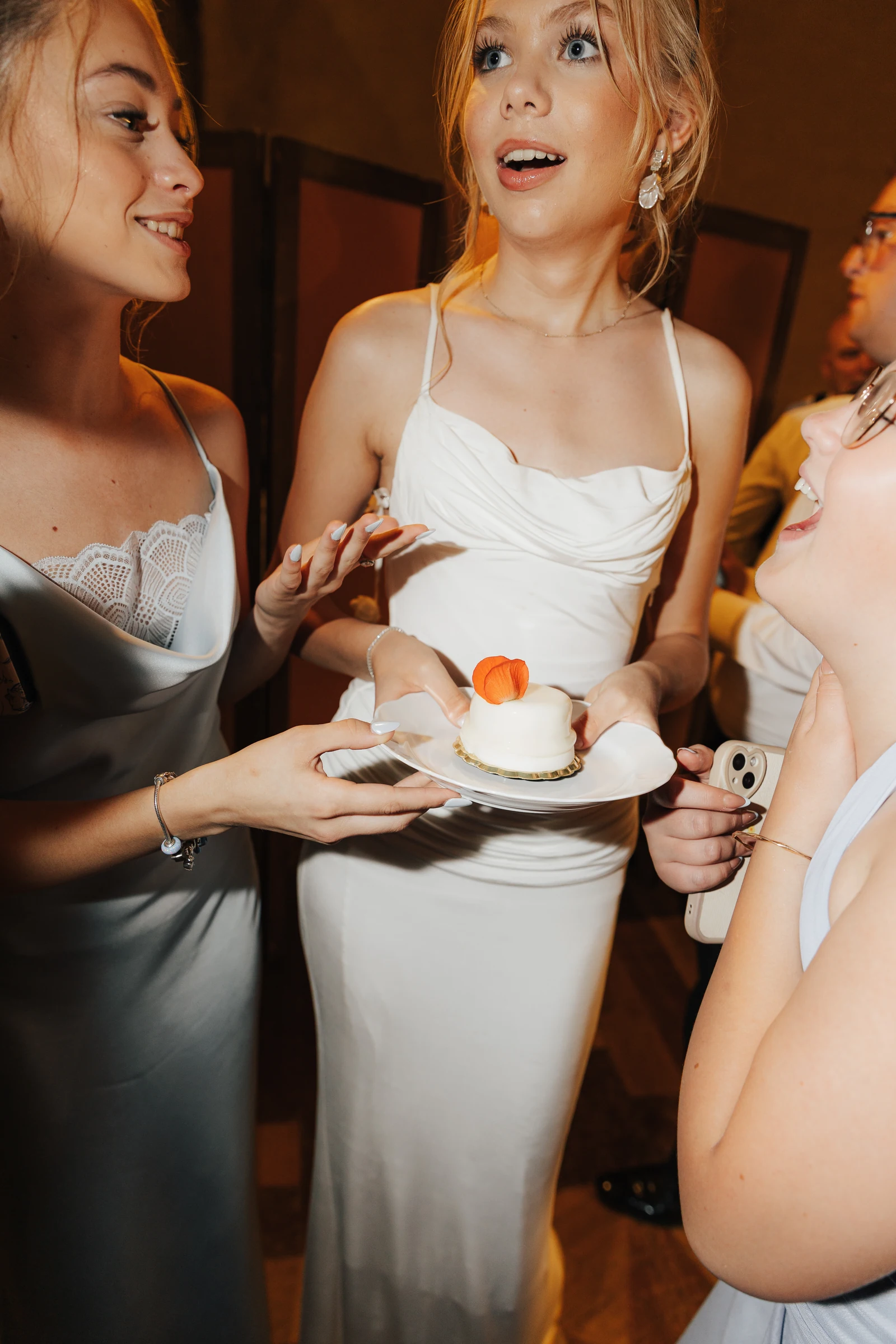 Guest holding a small dessert during the evening party at Villa Arvedi.