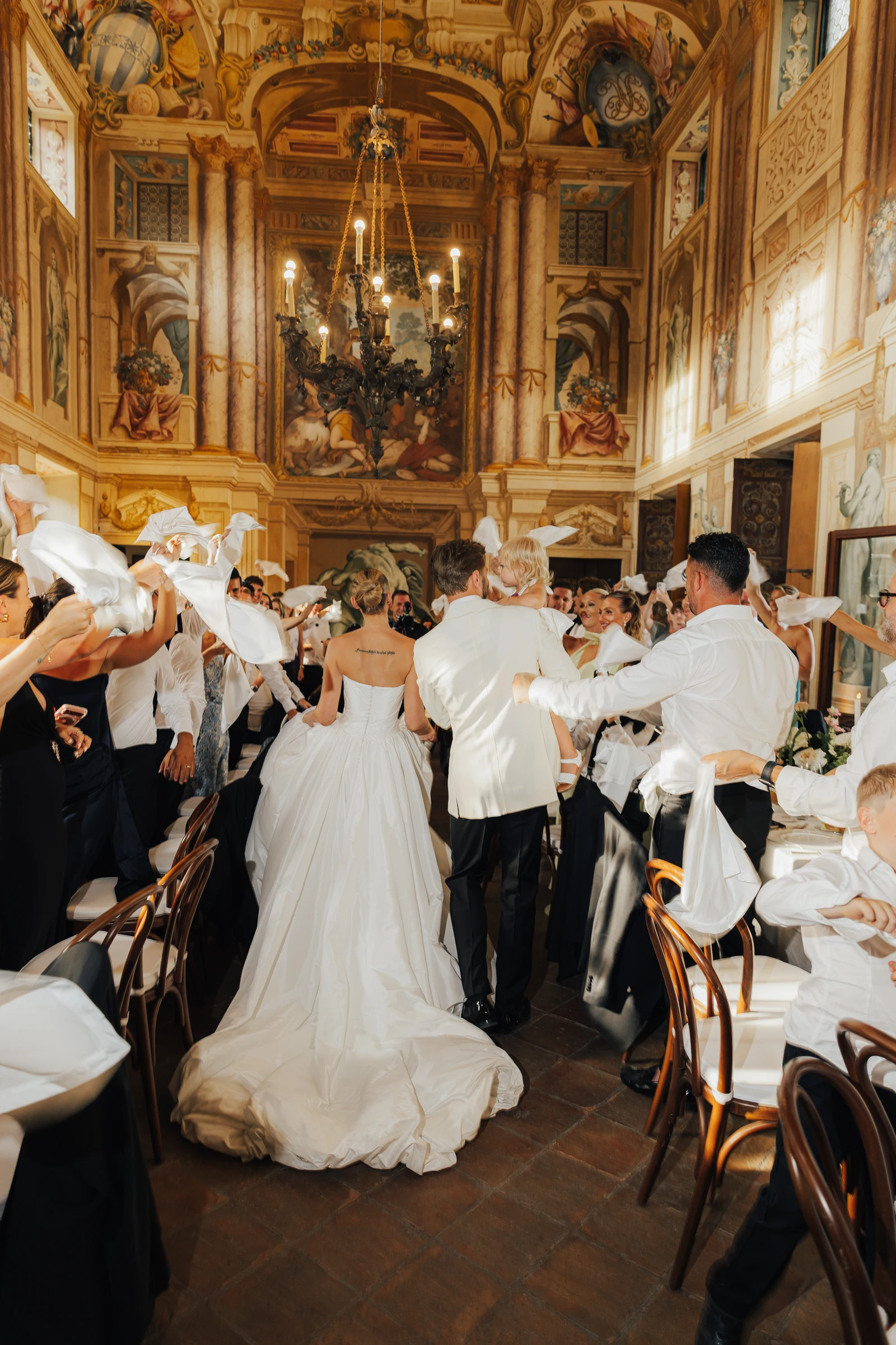 Guests celebrating with the newlyweds in the reception hall at Villa Arvedi.
