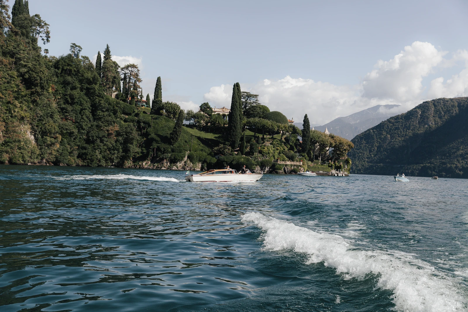 Villa del Balbianello and its lakeside gardens seen from a boat on Lake Como.
