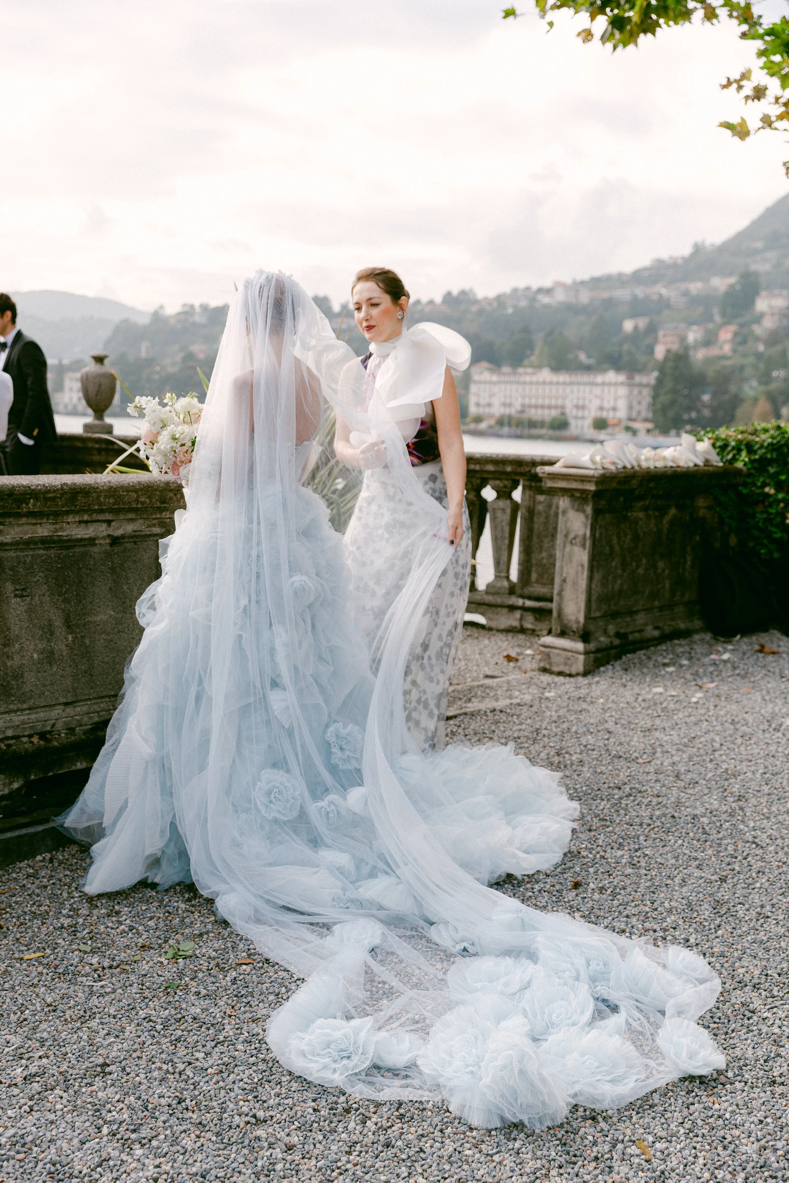 Bride with a flowing pale blue veil beside Lake Como at Villa Pizzo.