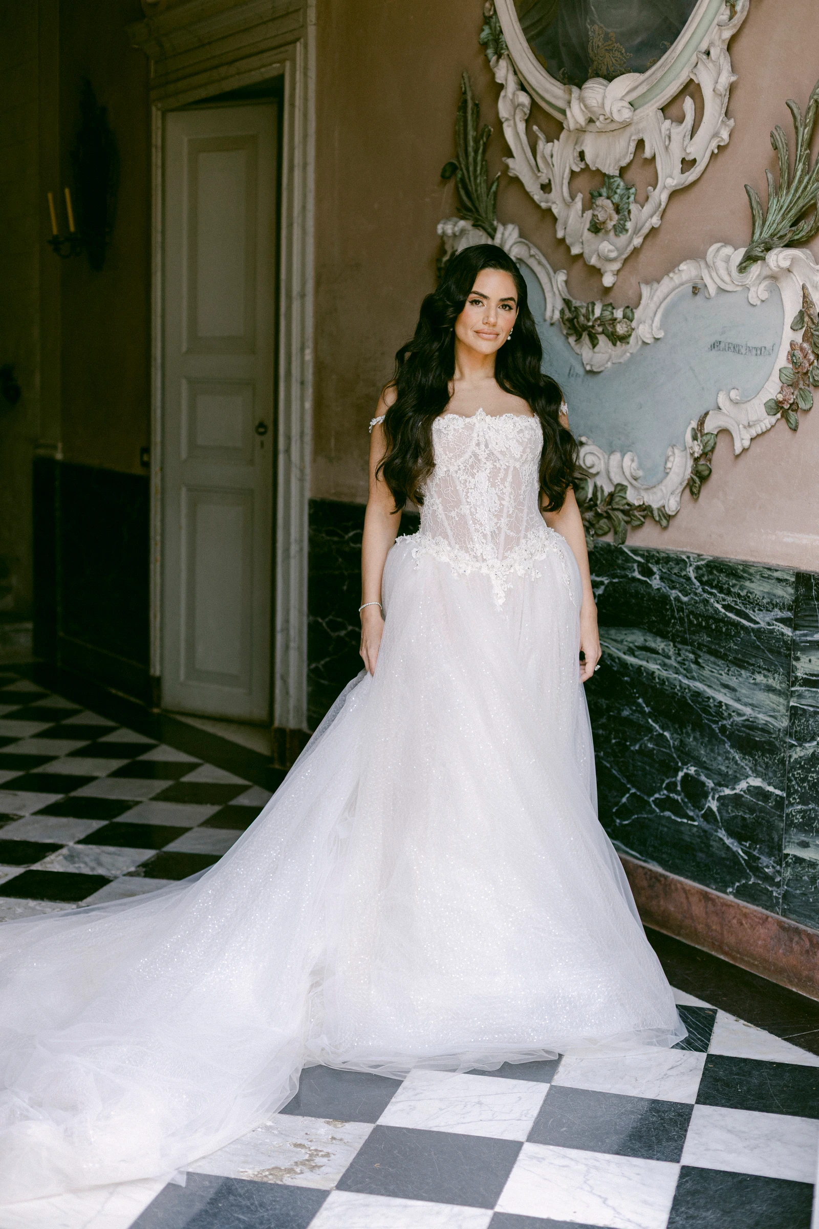 Bride in her wedding dress in an ornate room at Villa Pizzo on Lake Como.