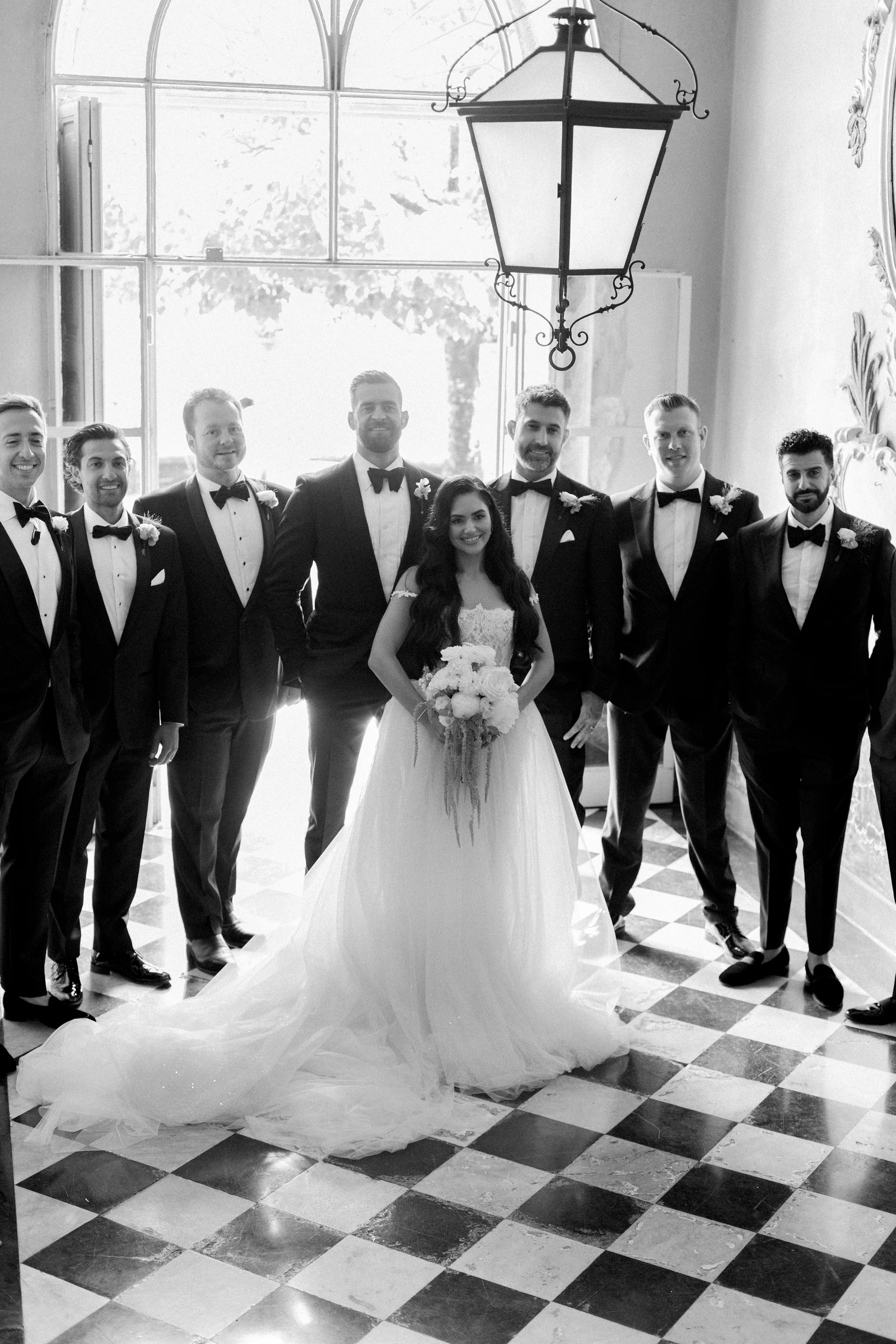 Bride and wedding party in black and white inside Villa Pizzo.