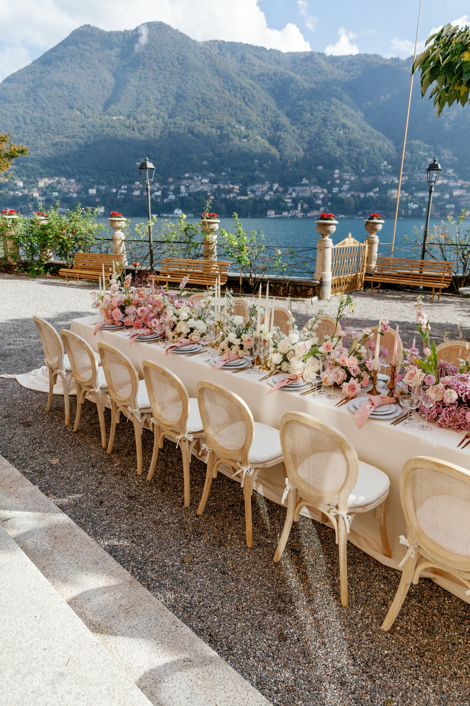 Flower-covered reception table overlooking Lake Como at Villa Pizzo.