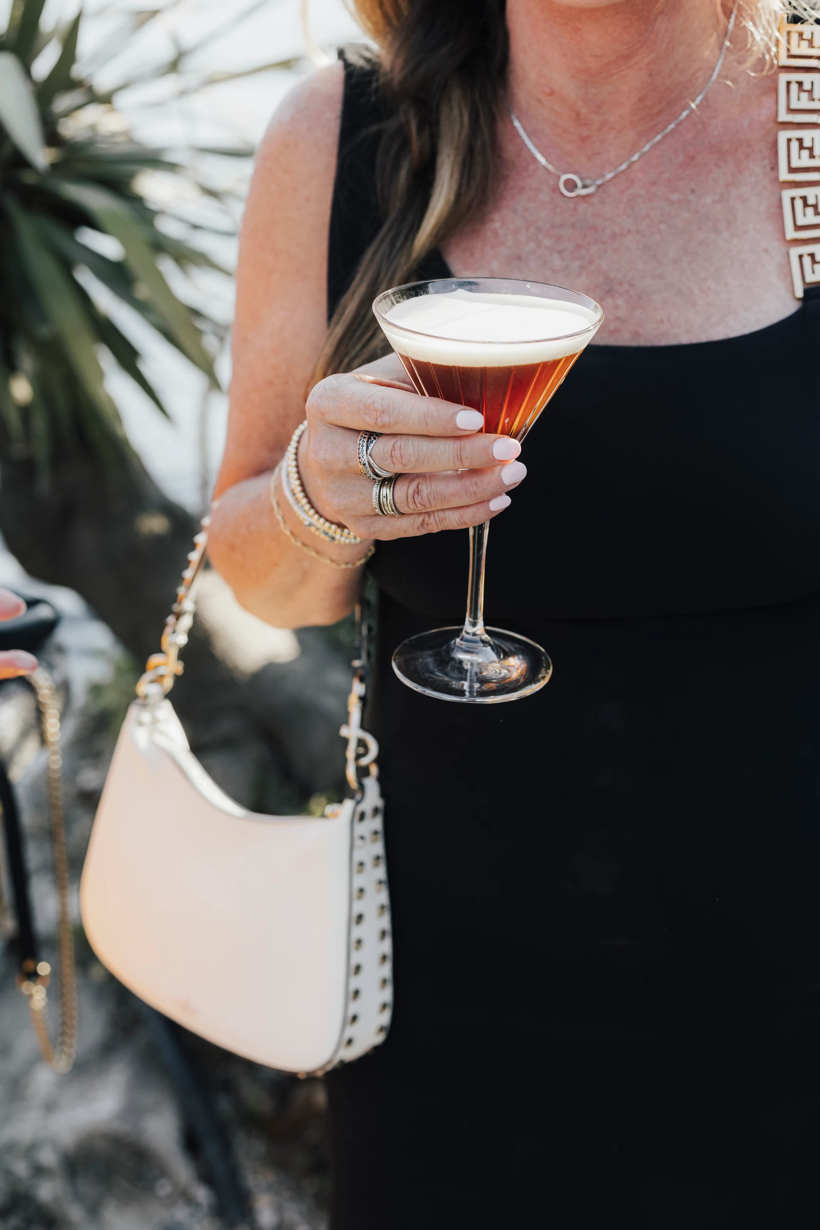 Wedding guest holding a cocktail during aperitivo at Villa Pizzo.