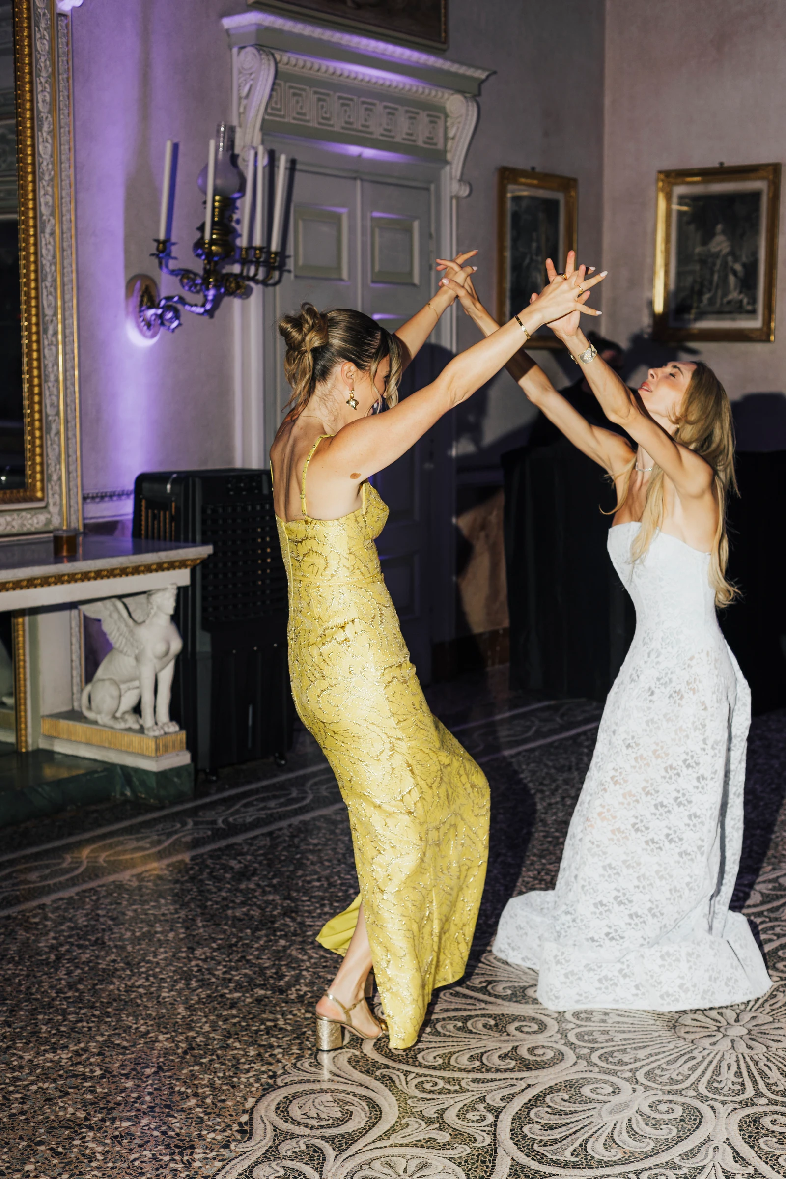 Wedding guests dancing inside Villa Pizzo during the evening party.