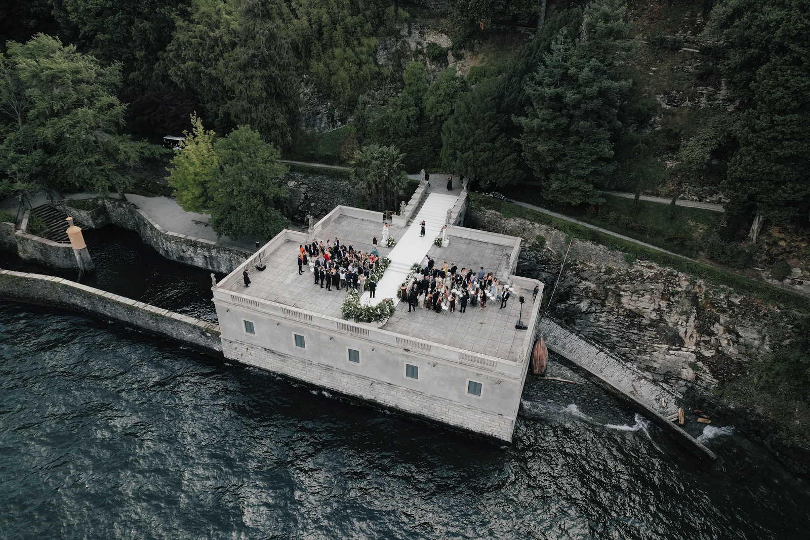 Aerial view of the wedding ceremony and guests on the lakeside terrace at Villa Pizzo.