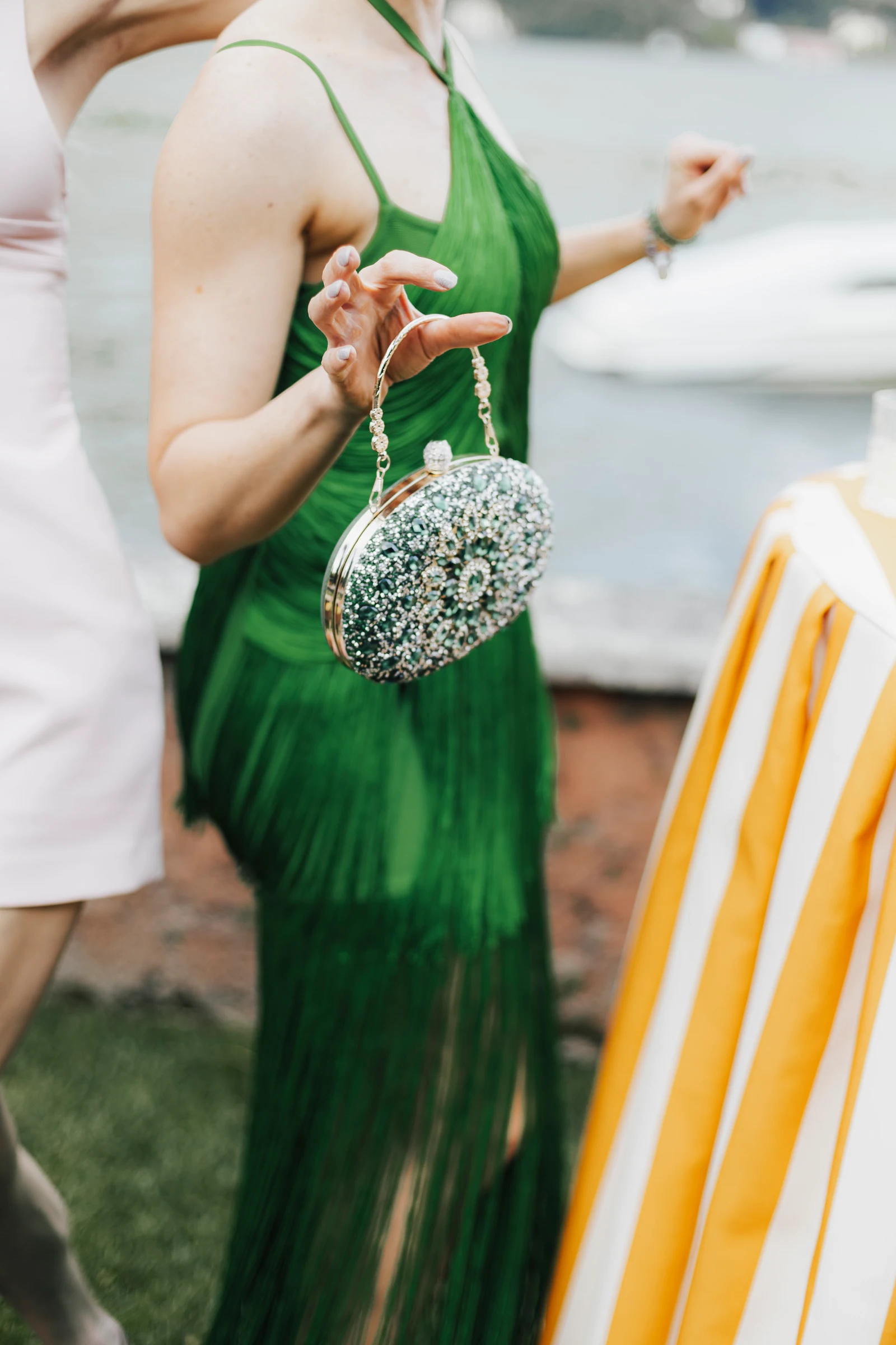 Guest’s green dress and crystal handbag at Villa Regina Teodolinda on Lake Como.